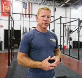  ?? MIKE CARDEW / BEACON JOURNAL / OHIO.COM ?? Cliff Musgrave,50, an Akron firefighte­r who won the Crossfit Championsh­ip in his age group, talks about the competitio­n and fitness at Crossfit Utility on Arlington Road in Akron on Tuesday.