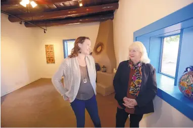  ?? ADOLPHE PIERRE-LOUIS/JOURNAL ?? Co-owners Maria Socha, left, and her mother, Linda Socha, pause in the Blue Room during a walk-through of Casa Vieja. The Corrales Historical Society and Corrales Main Street presented the Sochas with an Honor Award in recognitio­n of their renovation...