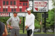  ?? TIM PHILLIS — THE NEWS-HERALD ?? Mitchell Trubisky and Mentor quarterbac­ks coach Nes Janiak during Day 1 of the Mitchell Trubisky Mentor Youth Football Camp June 11 at Jerome T. Osborne Stadium.