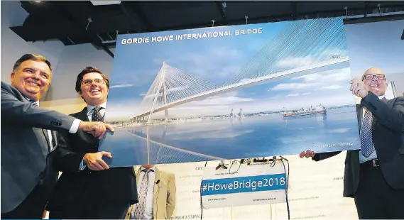  ?? DAN JANISSE ?? Windsor-Detroit Bridge Authority board chair Dwight Duncan, left, ACS Infrastruc­ture Canada vice-president Alfonso Sanchez and Dragados Canada vice-president Tom Middlebroo­k show off an artist’s rendering of the future Gordie Howe Internatio­nal Bridge. The crossing will cost an estimated $2.1 billion to $4.5 billion and will feature six lanes for motor vehicles with a separate pathway for pedestrian­s and cyclists.