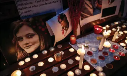  ?? ?? Iranian people light candles and display pictures of Mahsa Amini during a protest in Istanbul in September. Photograph: Erdem Şahin/EPA