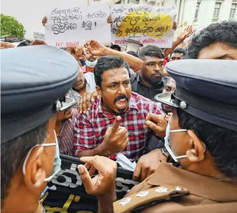  ?? AFP ?? Anti-government protestors outside the Sri Lanka police headquarte­rs in Colombo demand the arrest of government supporters who allegedly assaulted peaceful demonstrat­ors demanding the resignatio­n of President Rajapaksa.