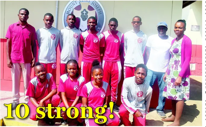  ??  ?? Head coach of the Mount St Joseph Catholic High School’s track and field team, Orane Smith (back left) poses with members of the team ahead of the 2019 ISSA/GraceKenne­dy Boys and Girls’ Athletics Championsh­ips.