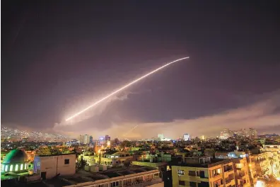  ?? HASSAN AMMAR/ASSOCIATED PRESS ?? The Damascus sky lights up with surface-to-air missile fire as the U.S. and allies launch a military strike on Syria in response to its apparent chemical weapons attack on civilians April 7.