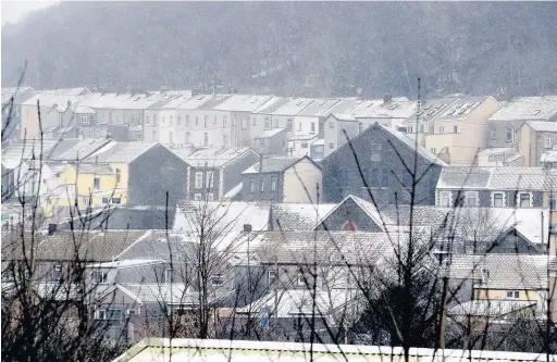  ??  ?? Snow covered roof tops and pavements in Porth, Rhondda