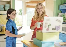  ?? ?? Reese is practical, single mom and accountant Debbie. She is shown with Wesley Kimmel who plays her character’s son Jack.