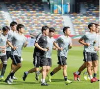  ??  ?? Japanese players during a team practice session ahead of their match against Oman on Sunday.