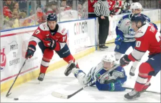  ?? Herald photo by Dale Woodard ?? Lethbridge Hurricanes forward Jett Jones and Swift Current Broncos defenceman Parker Hendren chase a loose puck along the boards while Canes forward Alex Thacker closes in during Western Hockey League action Saturday night at the Enmax Centre.