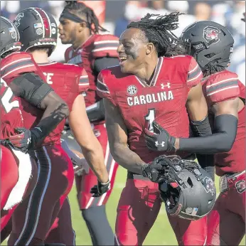  ?? SEAN RAYFORD/AP ?? South Carolina defensive back Jaycee Horn (1) celebrates with teammates Saturday after a win over Auburn.