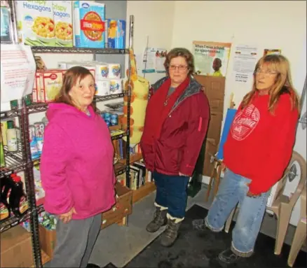  ?? PHOTO SPECIAL TO THE DISPATCH BY MIKE JAQUAYS ?? Verona Food Pantry volunteers, from left, Becky Harrington, Jennifer Centore, and Linda Finnerty pose on Jan. 4at their Durhamvill­e storage and distributi­on facility.