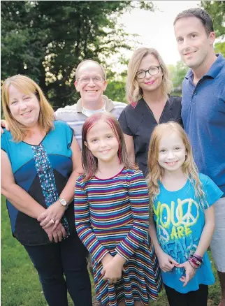  ?? ASHLEY FRASER ?? Eight-year-old Gianna-Lynn Favilla, bottom right, gets to live a normal life since family friend Ken Budel donated part of his liver to her for a transplant. At rear, from left, are her parents Sue and Chris, Stacy Budel and Ken Budel; in front with...