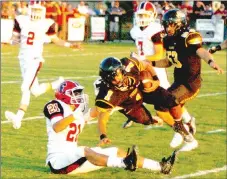  ?? MARK HUMPHREY ENTERPRISE-LEADER ?? Farmington defensive back Skyler Montez tackles Prairie Grove halfback Anthony Johnson after a long gain. Prairie Grove defeated the Cardinals, 35-21, Friday in the annual rivalry football game.