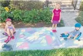  ?? COURTESY KARLEE KUNKLE ?? Organized by residents of Lake Nona’s Laureate Park neighborho­od, this colorful community activity encourages families to decorate their portion of the sidewalk.