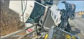  ?? HENRIETTA FIRE DEPT. ?? A FedEx truck hangs off the side of an overpass in upstate New York after a crash that left five people injured, including a child, officials said.