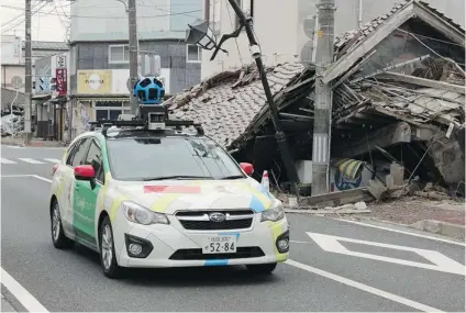  ?? GOOGLE/ AFP/ GETTY IMAGES ?? A Google car mounted with a Street View camera drives past a collapsed building in the abandoned city of Namie, Japan.