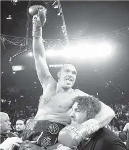  ?? ISAAC BREKKEN AP ?? Tyson Fury is carried off after beating Deontay Wilder for the heavyweigh­t title Saturday in Las Vegas. Wilder’s corner threw in the towel in the seventh round.