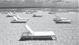  ?? LYNNE SLADKY AP ?? Empty chairs sit on the sand in Miami Beach in March.