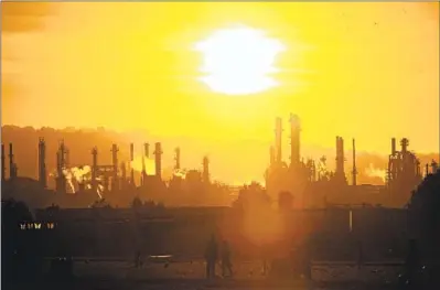  ?? Luis Sinco Los Angeles Times ?? YOUTH SOCCER players practice at Wilmington Waterfront Park in the shadow of the ConocoPhil­lips refinery.