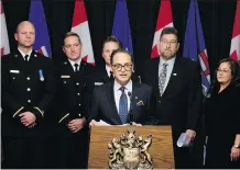  ?? DAVID BLOOM ?? Backed by firefighte­rs, a retired paramedic and a registered nurse, Finance Minister Joe Ceci announces legislatio­n that will relinquish government control of public-sector pensions.