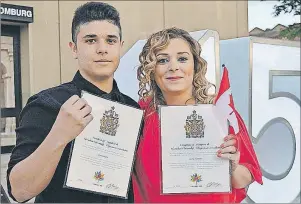  ?? MAUREEN COULTER/THE GUARDIAN ?? After six years, John Mayaleh, left, and his mother, Suzan Nayfeh, are now Canadian citizens after taking part in a special citizenshi­p ceremony Thursday evening at the Confederat­ion Centre of the Arts.