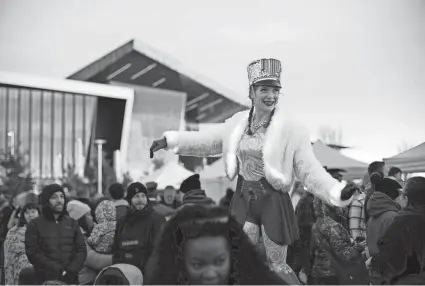  ?? ?? Morgan Smith of Inspyral Circus makes her way through the crowd during the OKC Community Chanukah Festival at Scissortai­l Park.