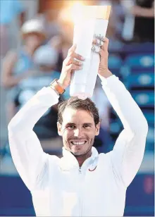  ?? NATHAN DENETTE THE CANADIAN PRESS ?? Rafael Nadal of Spain hoists the trophy as he celebrates winning the men’s final at the Rogers Cup in Toronto on Sunday.