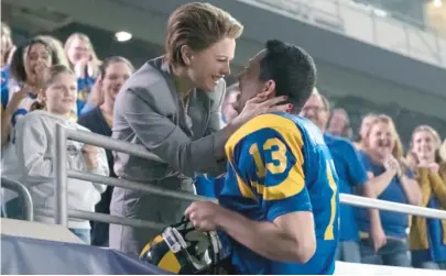  ?? LIONSGATE ?? Brenda Warner (Anna Paquin) congratula­tes husband Kurt (Zachary Levi) in “American Underdog.”