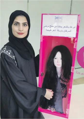  ?? Chris Whiteoak / The National ?? Amal Al Mazmi, a manager at the Friends of Cancer Patients, welcomes the generosity of Emiratis and the trend towards giving hair for wigs to lift patients’ self-esteem