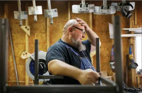  ?? ASSOCIATED PRESS ?? Jack Lyons, a contractor working on massive rocket test stands for NASA, stands in his workshop while spending the furlough on his small side business making props for marching bands, in Madison, Ala.