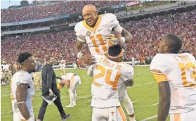  ?? DALE ZANINE, USA TODAY SPORTS ?? Quarterbac­k Joshua Dobbs (11) celebrates after his Hail Mary pass to Jauan Jennings lifted Tennessee by Georgia on Saturday.