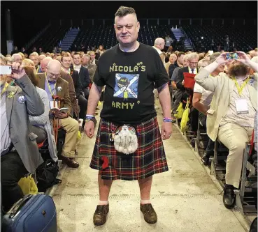  ??  ?? Nicola’s tartan army: Glasgow delegate Steven Davies shows his support for the party leader