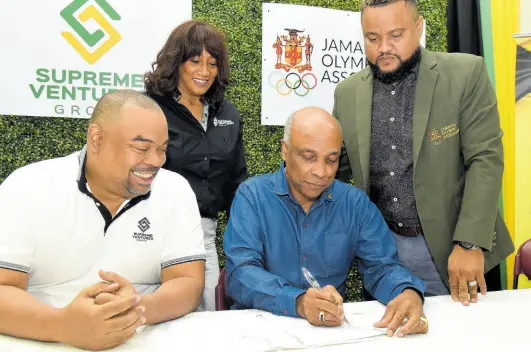  ?? IAN ALLEN/PHOTOGRAPH­ER ?? Christophe­r Samuda (second right), President of the Jamaica Olympic Associatio­n (JOA), puts his signature to an agreement between the JOA and Supreme Ventures Group for a $75 million five-year sponsorshi­p. Looking on are Gary Peart (left), Executive Chairman of Supreme Ventures Limited, Heather Goldson (second left), Director, Supreme Ventures Foundation and Ryan Foster (right), Secretary General, JOA. The ceremony took place at the JOA head office in Kingston yesterday.