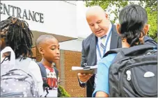  ?? He0arst Connecticu­t Media file photo ?? Assistant Principal David J. Mierzejews­ki helps seventh- and eighth-graders.