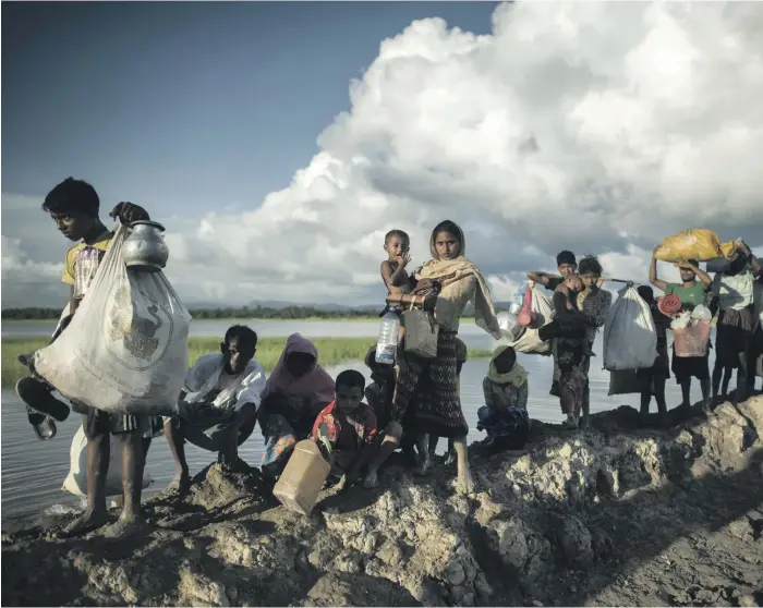  ?? AFP ?? Rohingya refugees crossing from Myanmar into Bangladesh. Since last year, at least 625,000 people, more than half the Rohingya population, have fled to escape persecutio­n