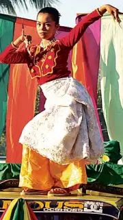  ??  ?? A“PANGALAY” dancer dressed in a traditiona­l “biyatawi” (fitted blouse) and “sawwal” (loose trousers) leads the street dancing of the Bongao delegation during the 41st Kamahardik­aan Festival in Tawi-Tawi province. The backdrop is the “sambulayan­g,” or colorful flags that traditiona­lly decorate native boats, like the lepa.