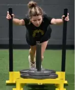  ?? Photos by Justin Guido/For the Post-Gazette ?? Charlotte Carothers, 14, of Upper St. Clair, performs a weighted sled push.