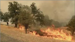  ?? THE ASSOCIATED PRESS ?? The Ranch Fire spots out ahead of the main fire in Spring Valley, Calif., on Monday.