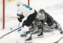  ?? Mark J. Terrill / Associated Press ?? Left wing Evander Kane scores on L.A. goaltender Jonathan Quick to give the Sharks a 21 lead in the second period.