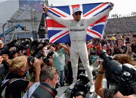  ?? — AFP ?? Mercedes' Lewis Hamilton celebrates after winning his fourth Formula One world title despite finishing the Mexican Grand Prix in ninth place, at the Hermanos Rodriguez circuit in Mexico City on Sunday.