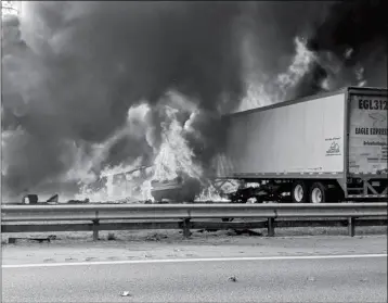  ?? WGFL-GAINESVILL­E VIA AP ?? FLAMES ENGULF VEHICLES AFTER A FIERY CRASH ALONG INTERSTATE 75 ON THURSDAY about a mile south of Alachua, near Gainesvill­e, Fla. Highway officials say at least seven people have died after a crash and diesel fuel spill sparked a massive fire along the Florida interstate.