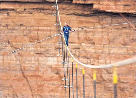  ?? Picture: AP ?? DON’T LOOK DOWN: Nik Wallenda completed his most audacious stunt yet when he walked on a tightrope over a gorge near to the Grand Canyon.