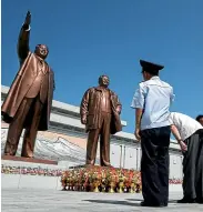  ?? AP ?? People pay their respects in front of bronze statues of the late leaders Kim Il Sung, left, and Kim Jong Il at Munsu Hill in Pyongyang, as North Korea marked the anniversar­y of Kim Il Sung’s death yesterday.