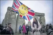  ?? BEN BIRCHALL — PA VIA AP ?? People inside the stone circle during summer solstice at Stonehenge watch the sun rise at dawn of the longest day of the year, in Amesbury, England, Monday.