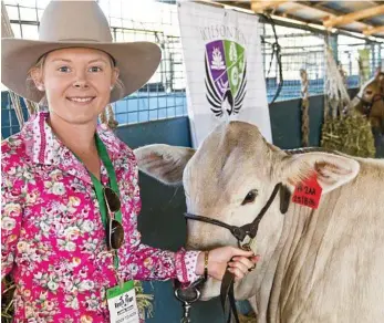  ?? PHOTOS: NEV MADSEN ?? ON SHOW: Wilsonton State High School teacher Hanna Redding is on hand to help students at the Queensland Beef Expo yesterday.