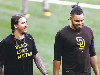  ?? K.C. ALFRED U-T ?? Ailing starters Mike Clevinger and Dinelson Lamet walk off the field during Monday’s practice for the NLDS.