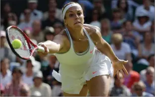  ?? Associated Press ?? Sabine Lisicki of Germany plays a return to Agnieszka Radwanska of Poland on Thursday during their Women’s singles semifinal match at the All England Lawn Tennis Championsh­ips in Wimbledon, London.