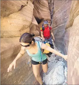  ?? Brian van der Brug
Los Angeles Times ?? MARCELA PRADO and Ray Regalado explore Keyhole Canyon in Zion National Park, Utah, last weekend. Seven hikers died there during a flash flood on Sept. 14.