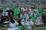  ?? PICTURE: AP ?? TRIUMPHANT: Iran’s national soccer team players celebrate after winning their 2018 World Cup qualifying soccer match at the Azadi Stadium in Tehran. Iran became the second team to qualify for the 2018 World Cup by beating Uzbekistan 2-0.