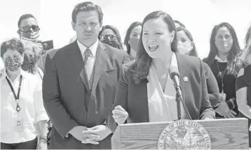  ?? WILFREDO LEE/AP ?? Florida Attorney General Ashley Moody speaks alongside Gov. Ron DeSantis during a news conference Thursday at PortMiami in Miami. DeSantis announced a lawsuit against the federal government and the CDC, demanding that cruise ships be allowed to sail.