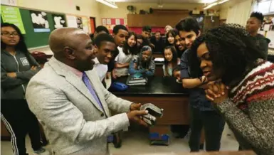  ??  ?? Gala, who still likes to be involved in teaching, demonstrat­es a physics experiment to Grade 12 students.